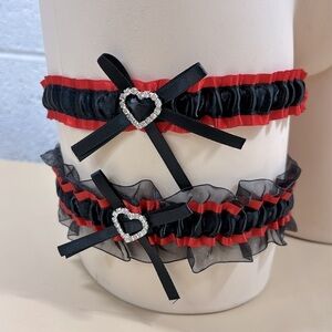 NWOT Pair of black and red garter belts​​​​​​​